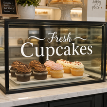 Load image into Gallery viewer, Fresh cupcakes vinyl decal on bakery display cabinet with cupcakes inside a glass food counter.