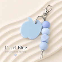 Load image into Gallery viewer, Blue personalised teacher bag charm with acrylic apple name tag, silicone beads and keyring hardware for teacher appreciation gifts.