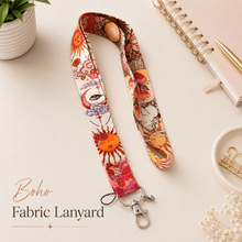 Load image into Gallery viewer, Boho fabric lanyard with colourful sun and floral print, silver clasp and keyring, styled on a neutral desk background for teachers and ID badges.
