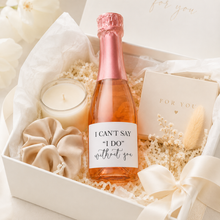 Load image into Gallery viewer, Bridesmaid proposal mini rosé bottle with “I can’t say I do without you” label in a luxury bridal gift hamper with candle and neutral gift packaging

