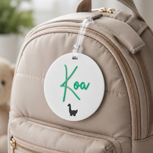 Load image into Gallery viewer, Personalised acrylic bag tag for kids attached to a nursery backpack with custom name and clear jelly strap
