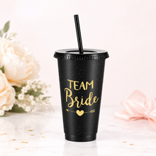 Load image into Gallery viewer, Black Team Bride cup with gold lettering and straw, styled as a bridal party gift for bridesmaid proposal bags and hen parties.
