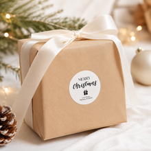 Load image into Gallery viewer, Modern Merry Christmas personalised sticker on kraft wrapped gift with neutral ribbon and festive decor.
