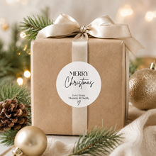 Load image into Gallery viewer, Modern minimalist personalised Christmas sticker on kraft wrapped gift with neutral ribbon and festive Christmas decor.

