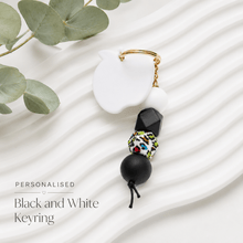 Load image into Gallery viewer, Monochrome personalised teacher keyring with white acrylic apple tag, black and white silicone beads and silver clasp.
