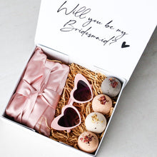 Load image into Gallery viewer, Elegant personalised bridesmaid proposal box with heart-shaped glasses, satin robe, handmade bath bombs, and a custom gift box with ribbon.
